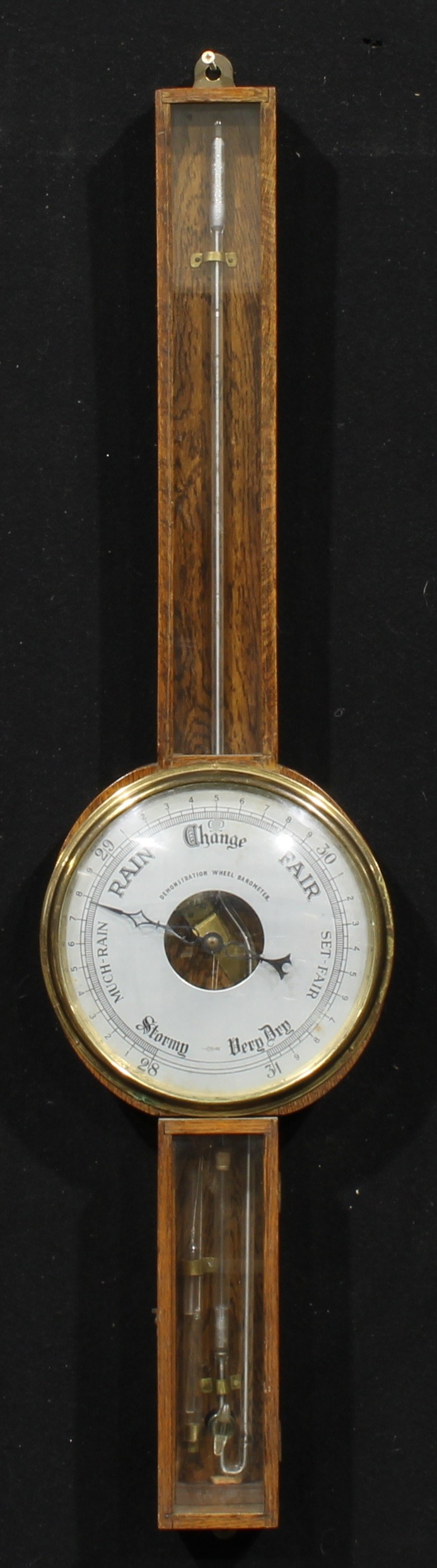 An early to mid 20th century oak wheel barometer, 19.5cm circular register inscribed DEMONSTRATION