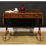 A Regency mahogany sofa table, rosewood crossbanded satinwood banded rounded rectangular top with