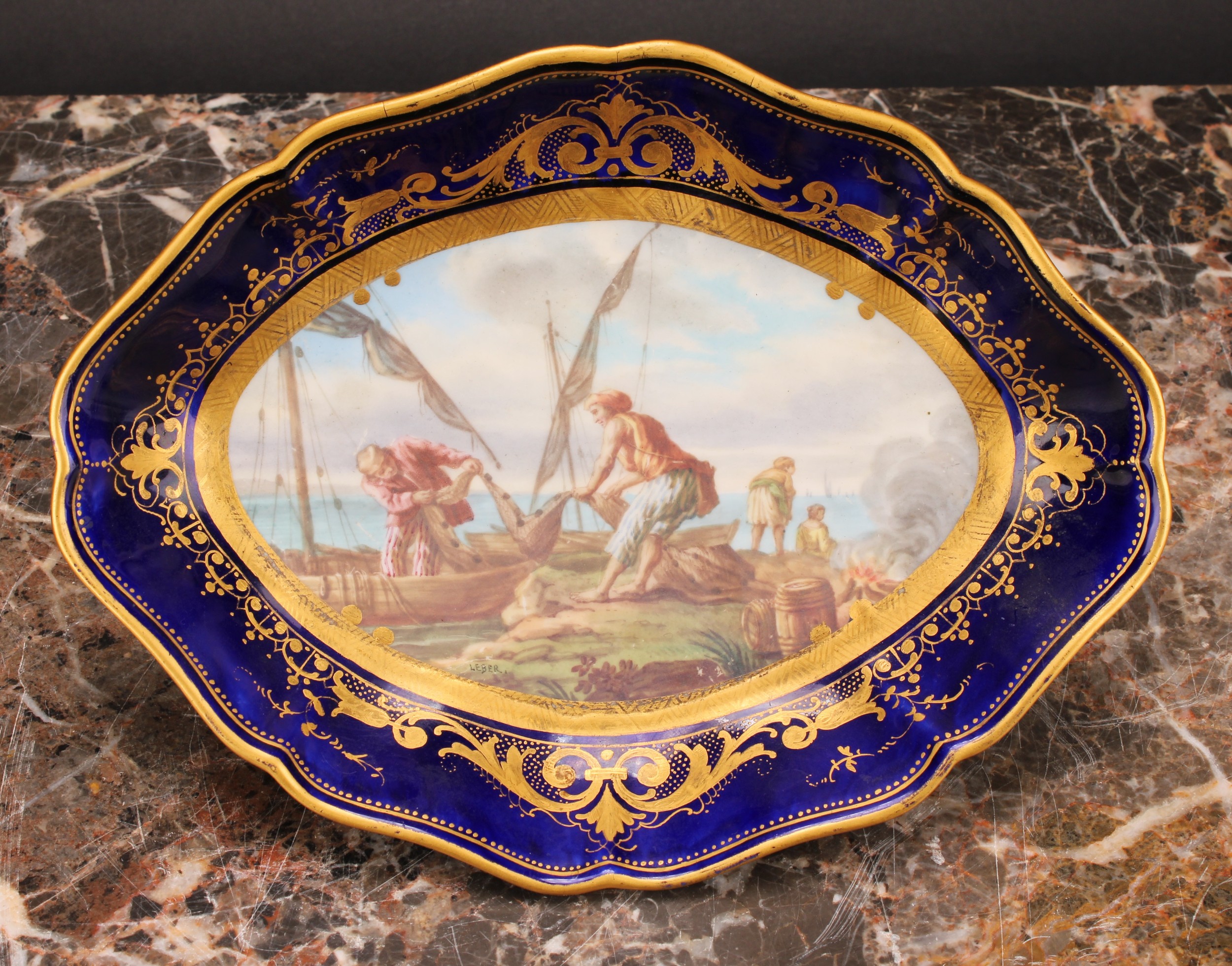 A Sevres shaped oval dish, painted by Leber, signed, with fishermen unloading their catch, the - Image 2 of 4