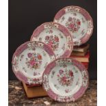 A set of four 18th century Chinese export shaped circular soup plates, painted in the famille rose