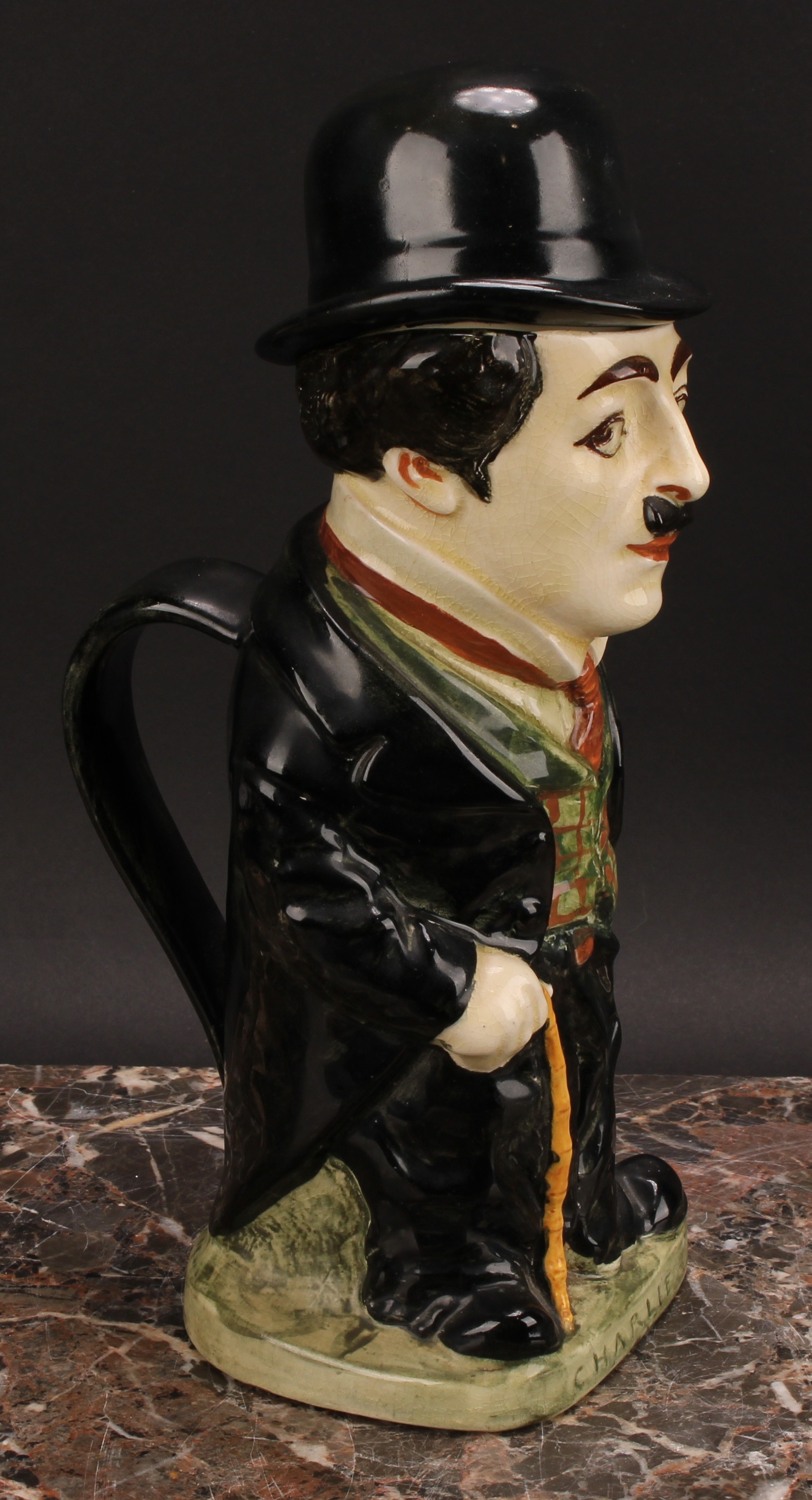 A Royal Doulton jug and cover, modelled as Charlie Chaplin, he stands wearing baggy black suit - Bild 3 aus 7