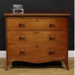 An early Victorian mahogany bachelor’s chest, oversailing top above a slide and three long graduated