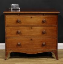 An early Victorian mahogany bachelor’s chest, oversailing top above a slide and three long graduated
