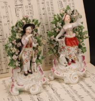 A pair of Derby patch mark figures, Shepherd and Shepherdess, he standing playing a horn with a