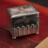 An Edwardian silver half-fluted retangular tea caddy, of George III design, hinged cover with