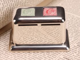 An Edwardian silver rounded rectangular stamp box, the hinged cover with two stamp apertures above