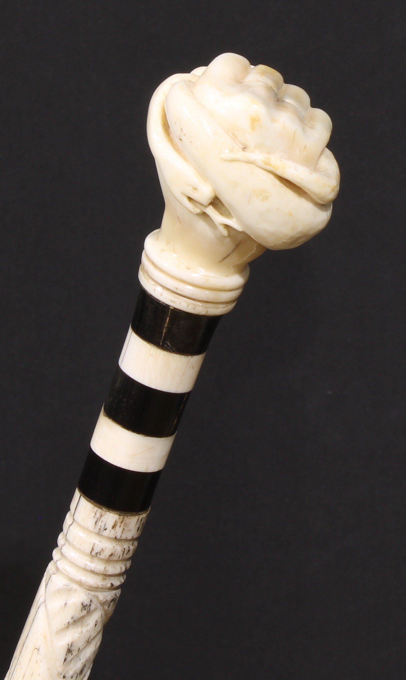 A 19th century sailor's maritime whale bone walking stick, the pommel carved as a fist grasping a - Image 3 of 4