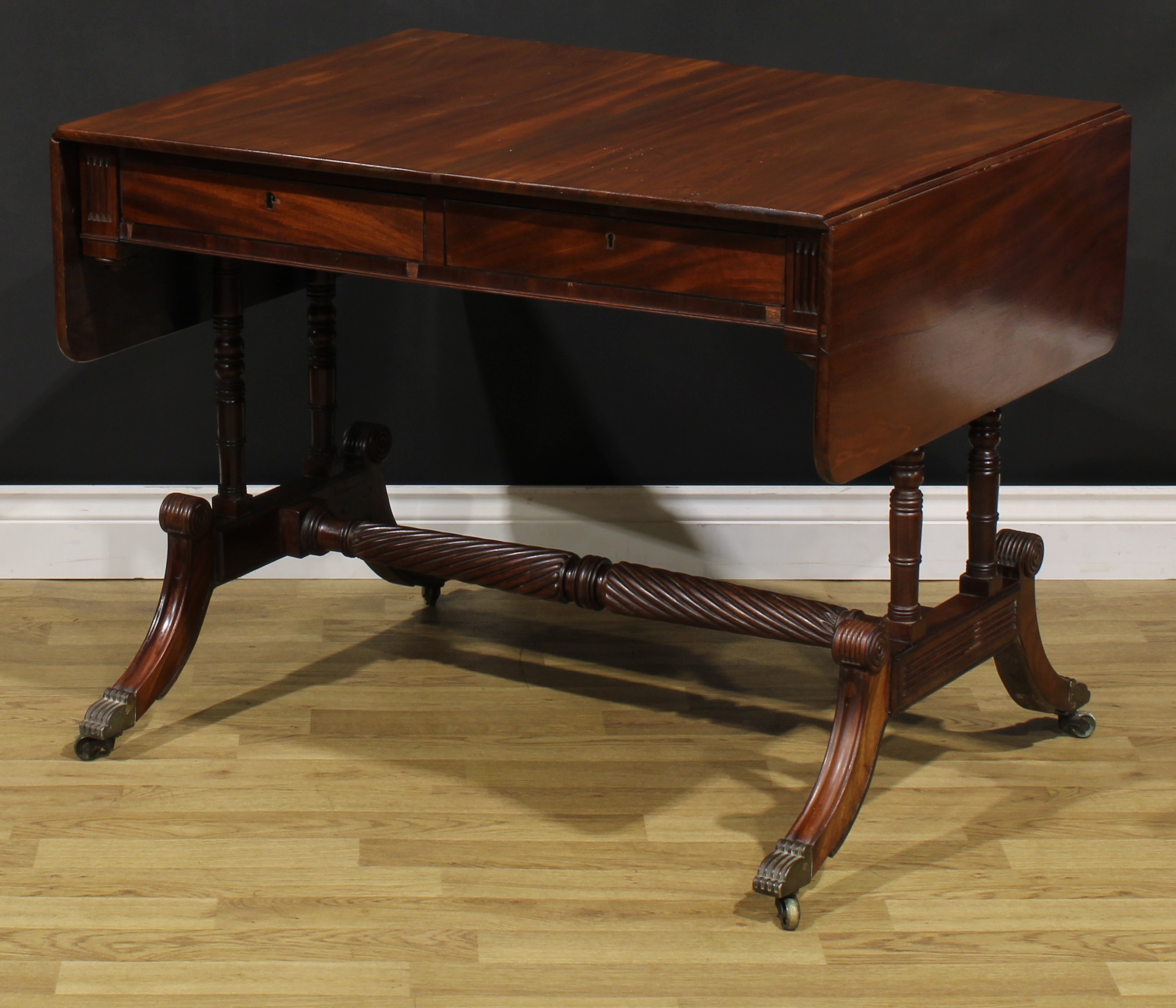 A Regency mahogany sofa table, possibly Irish, rounded rectangular top with fall leaves above a pair - Image 6 of 7