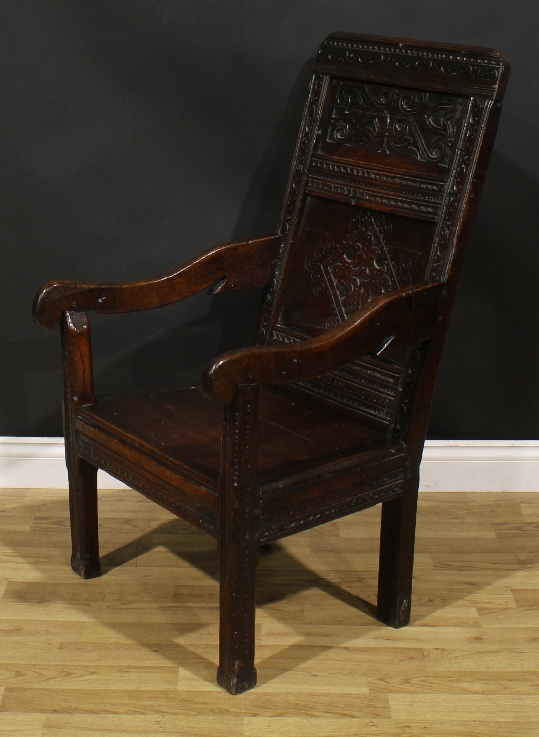A 17th century oak wainscot armchair, rectangular panel back carved with lozenges and leafy scrolls, - Image 3 of 4