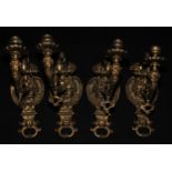 A set of four Renaissance Revival gilt bronze wall sconces, cast with Bacchic masks, 38cm long,