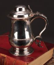 An early George III silver baluster tankard, hinged domed cover, chair-back thumbpiece, scroll