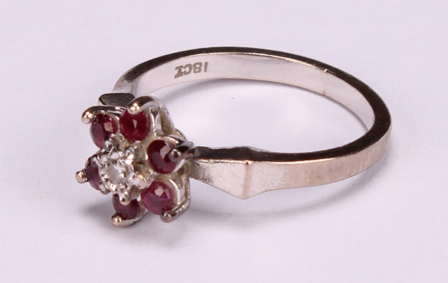 A diamond and sapphire square set cluster ring, the central cushion cut stone within a border of - Image 7 of 8