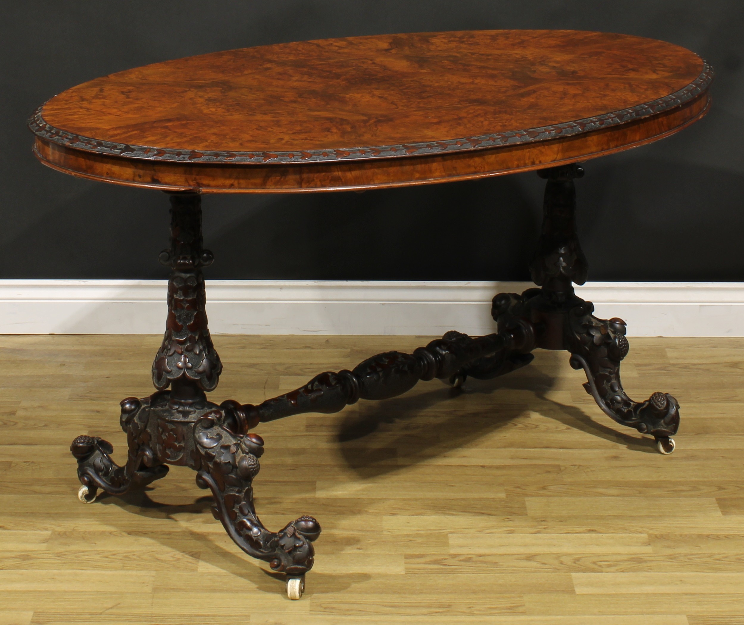 A Victorian Irish walnut and mahogany centre table, oval quarter-veneered top with carved edge, - Image 3 of 3