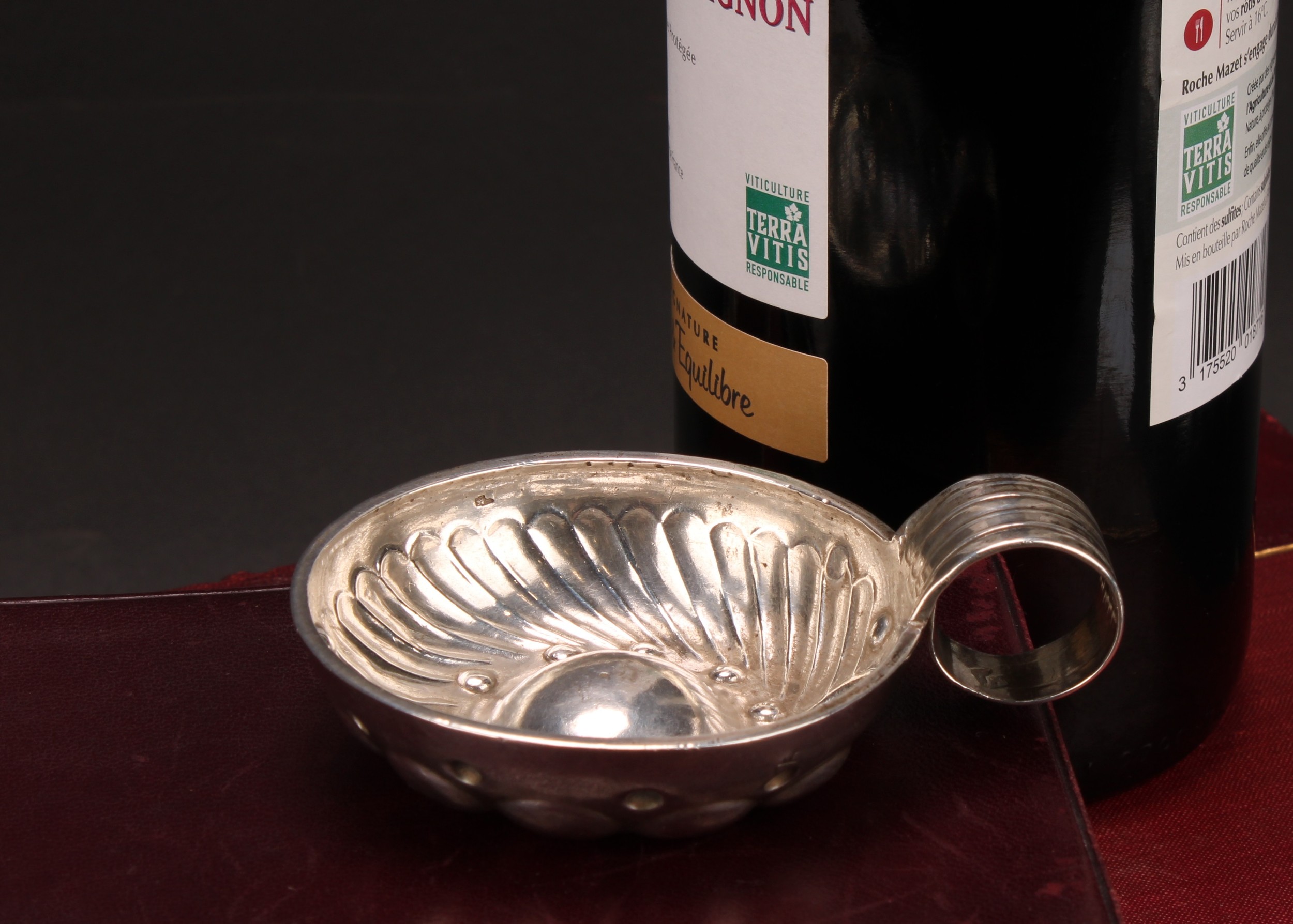 A French silver wine taster, fluted and chased, loop handle, inscribed Ernest Garcelon, 7cm diam,