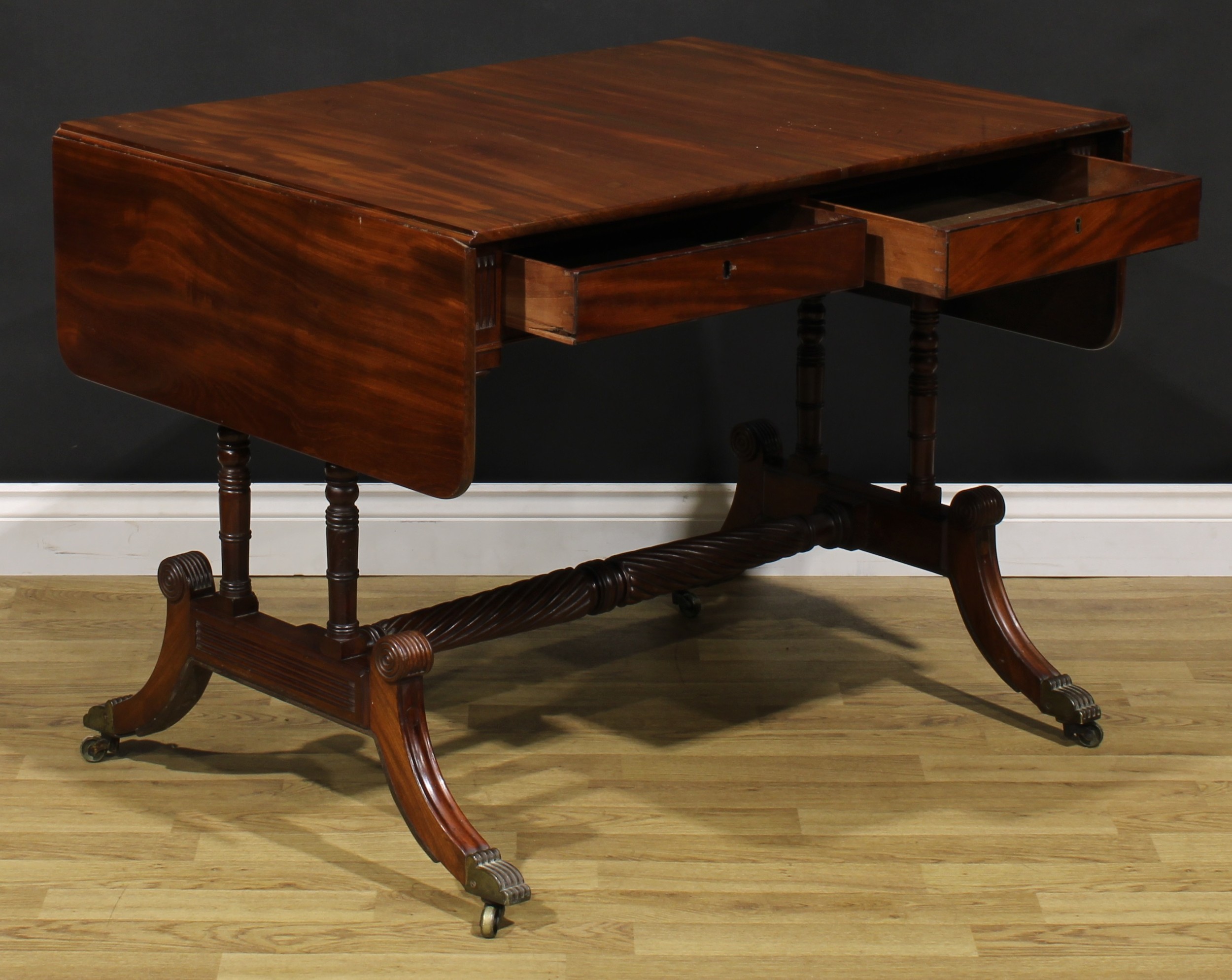 A Regency mahogany sofa table, possibly Irish, rounded rectangular top with fall leaves above a pair - Image 5 of 7