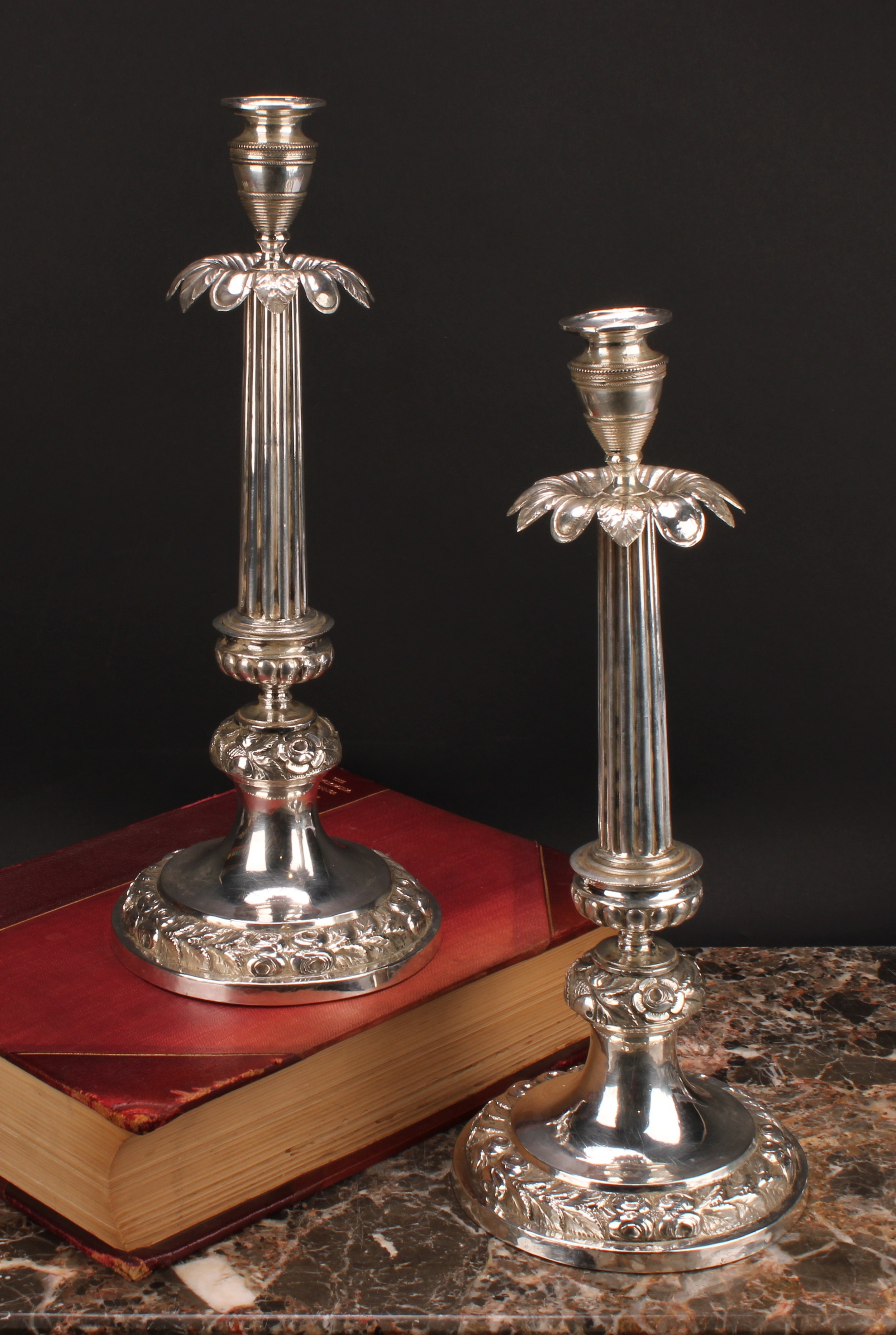 A pair of Italian silver table candlesticks, campana sconces, stiff leaf drip pans, fluted pillars