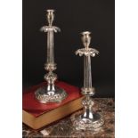 A pair of Italian silver table candlesticks, campana sconces, stiff leaf drip pans, fluted pillars