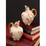 A pair Royal Worcester flat back jugs, decorated in the Aesthetic manner with floral sprays in muted