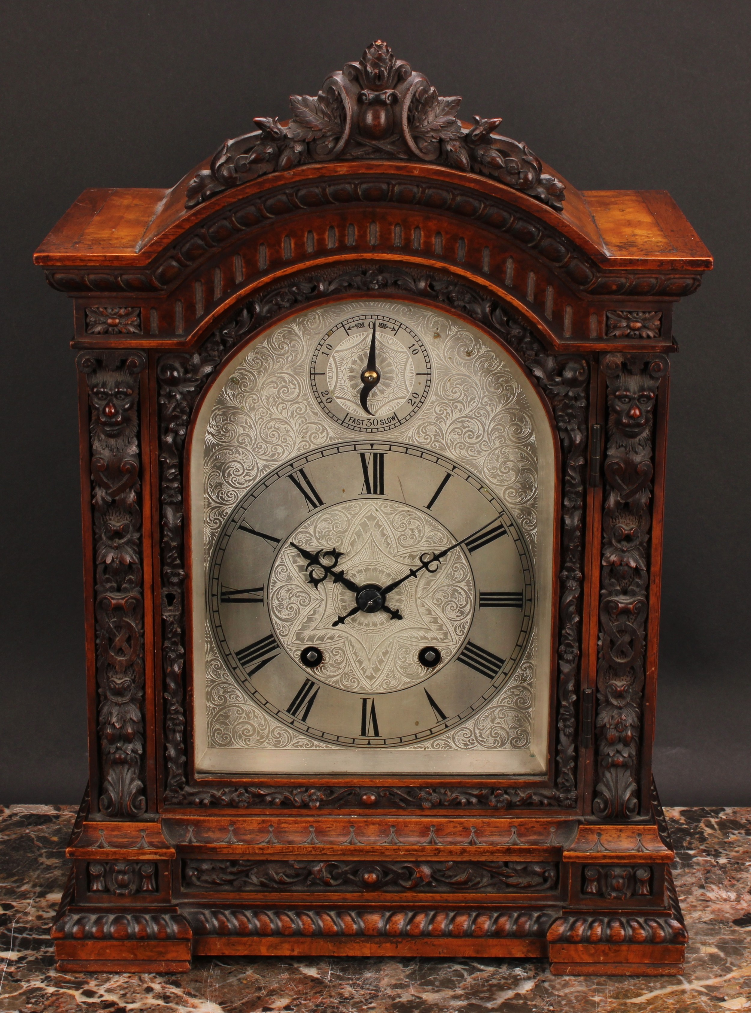 A Victorian walnut bracket clock, 15cm arched silvered dial profusely engraved with scrolling