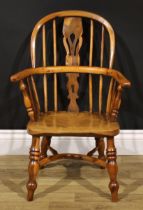 A 19th century yew and elm child’s Windsor elbow chair, pierced splat, crinoline stretcher, 69cm