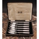 Liberty & Co - a set of six Arts and Crafts silver pastry forks, the terminals chased with