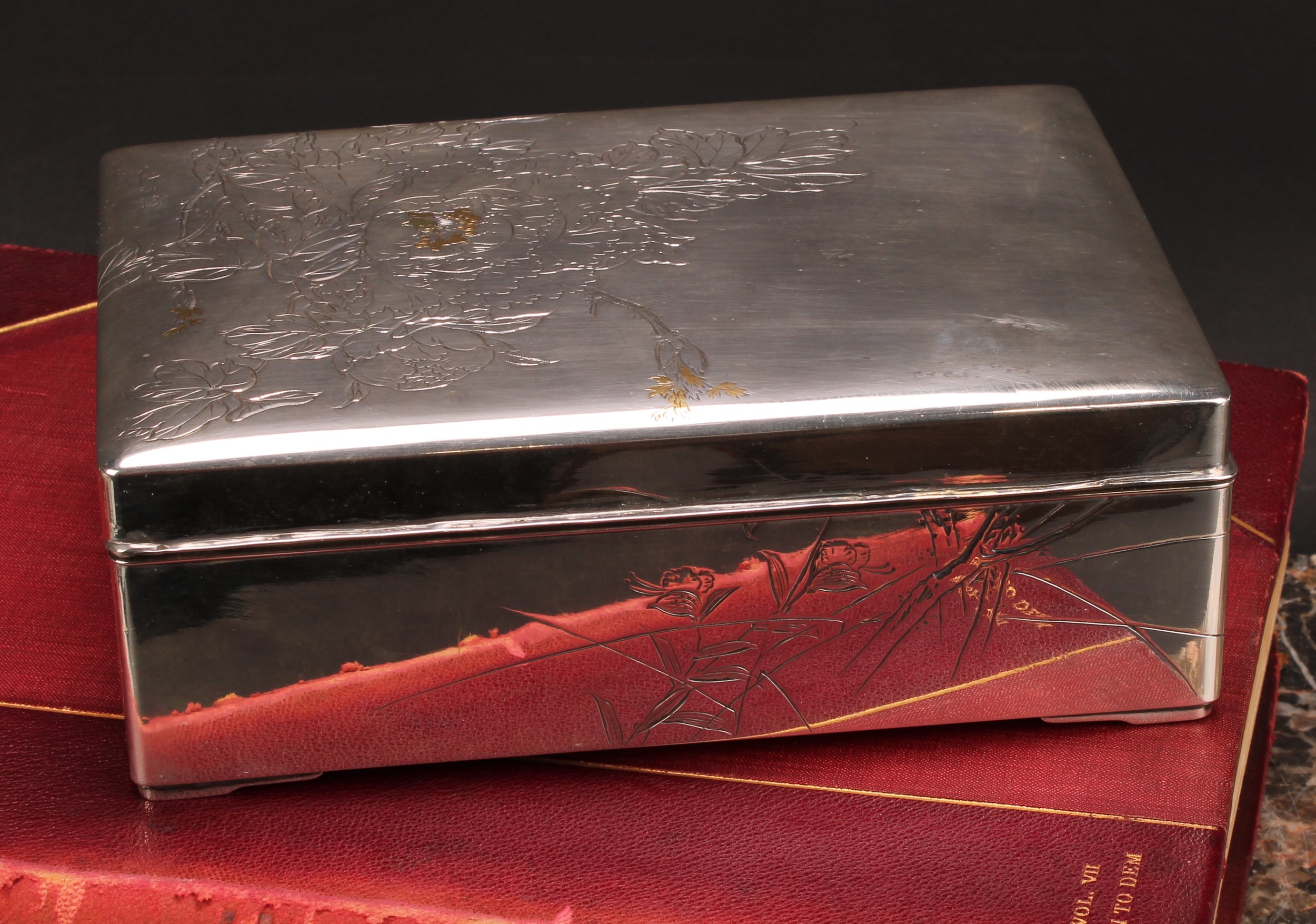 A large Japanese silver and mixed metal rectangular cigar box, hinged cover engraved with