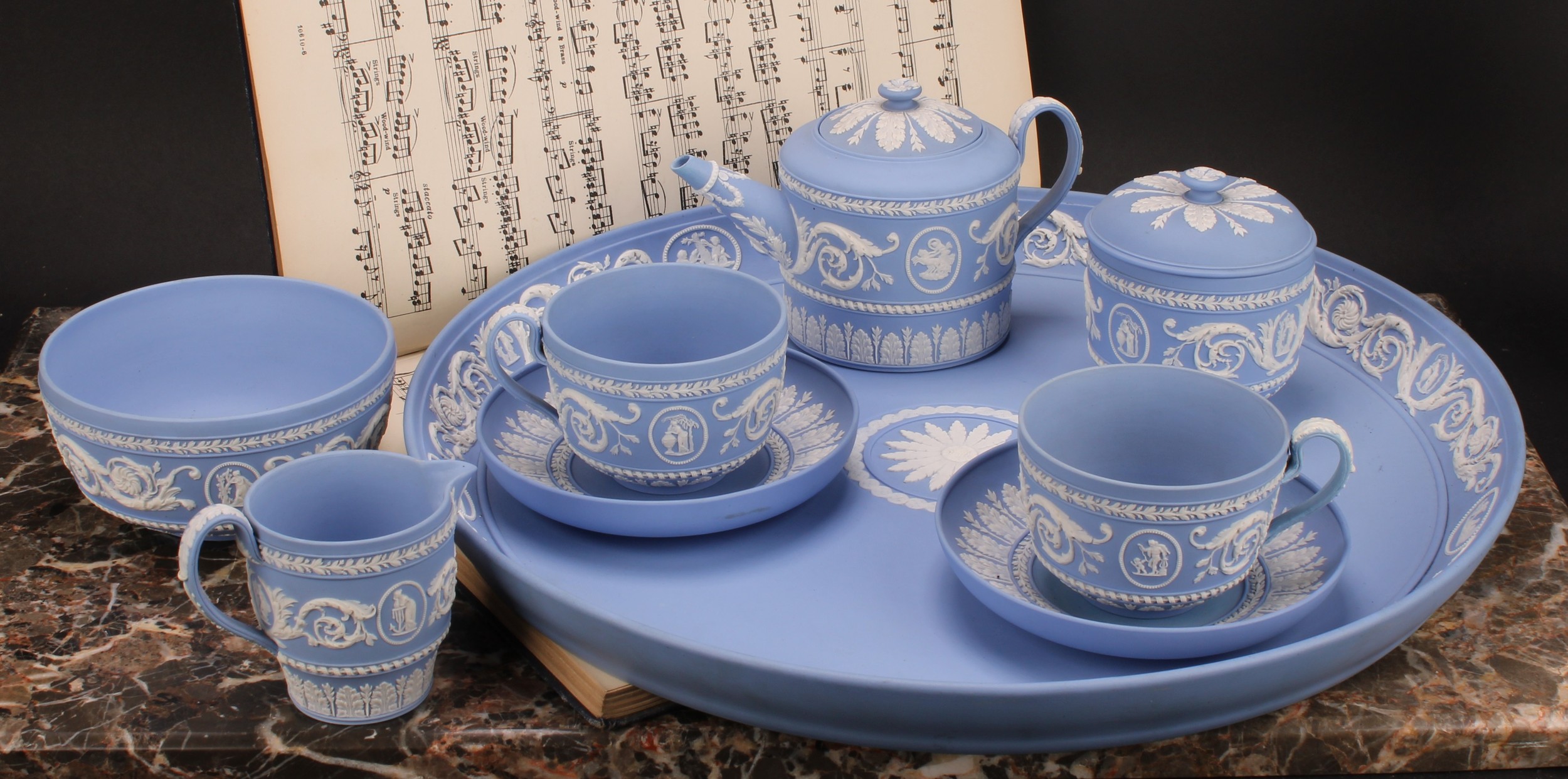 A Wedgwood jasperware cabaret set, comprising teapot, milk jug, sucrier and cover, two cups and
