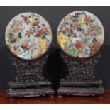 A pair of Chinese hardstone table screens, each circular tablet applied in coloured specimens with