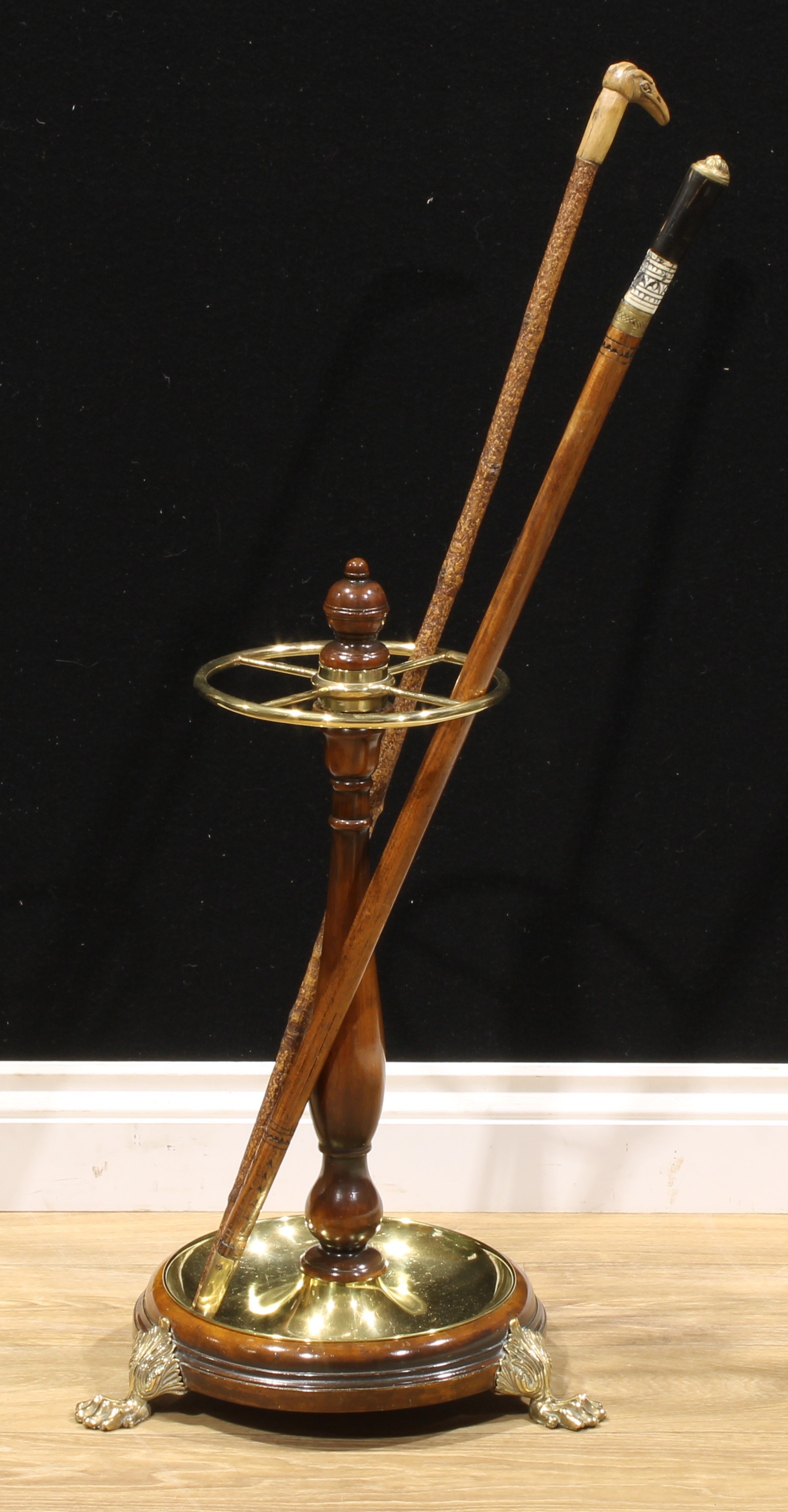 A 19th century design walnut and brass-mounted walking stick stand, turned baluster and finial,