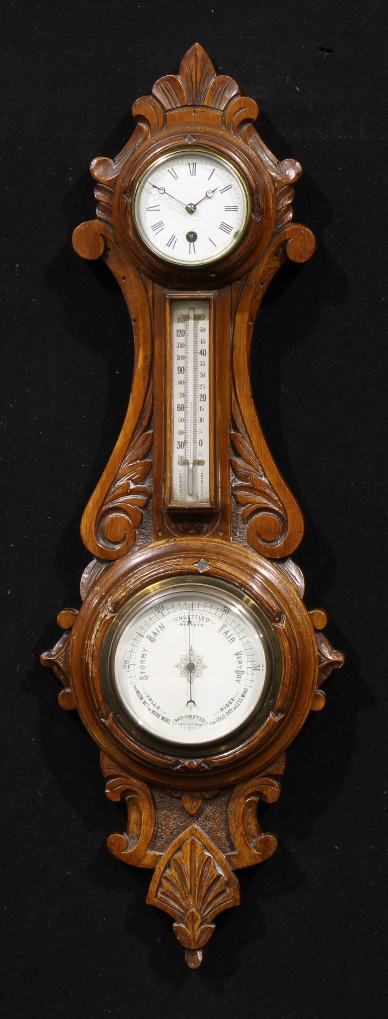 A late Victorian oak wheel weather station timepiece, 8cm circular clock dial inscribed with Roman