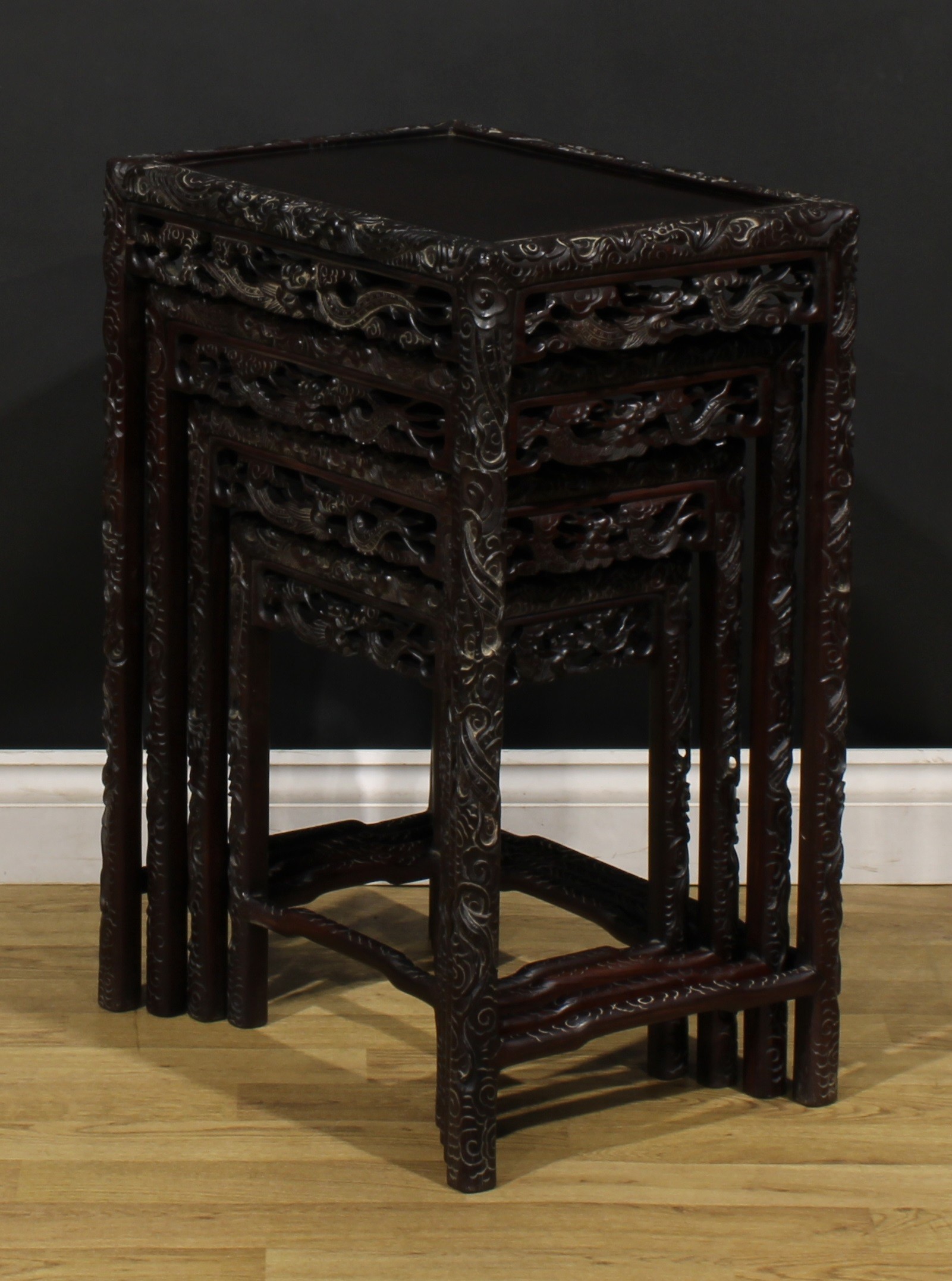 A set of Chinese hardwood quartetto tables, each carved throughout with dragons, the largest 70. - Image 5 of 6