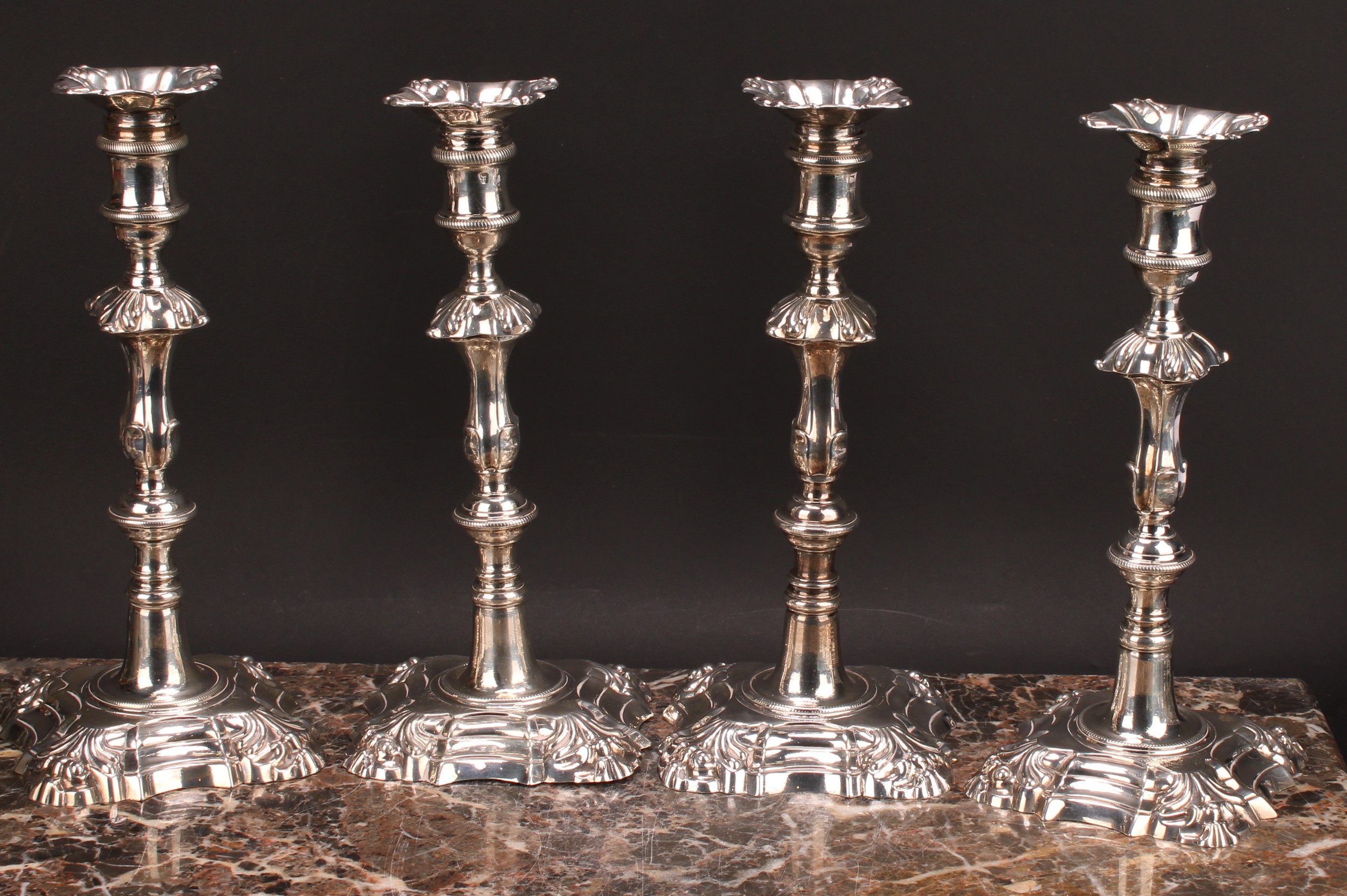 A composed set of four George II/early George III cast table candlesticks, detachable nozzles, - Image 2 of 14