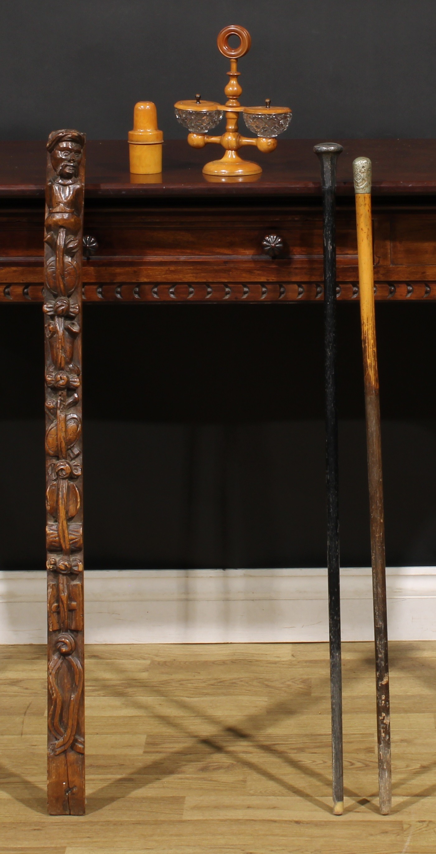 A 19th century walnut pilaster, carved with a herm and pendants, 91cm long; a French boxwood treen