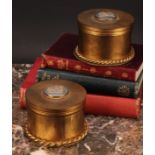 A pair of gilt metal circular dressing table boxes and covers, the covers set with a circular blue