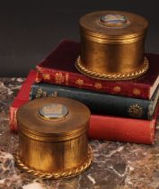 A pair of gilt metal circular dressing table boxes and covers, the covers set with a circular blue