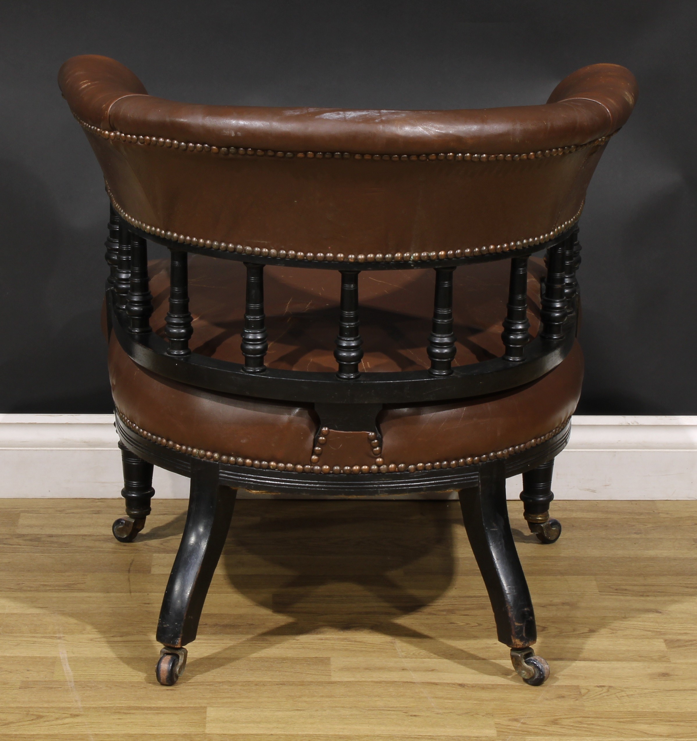 A late Victorian ebonised club or library chair, stuffed-over upholstery, turned forelegs, 69cm - Image 4 of 4