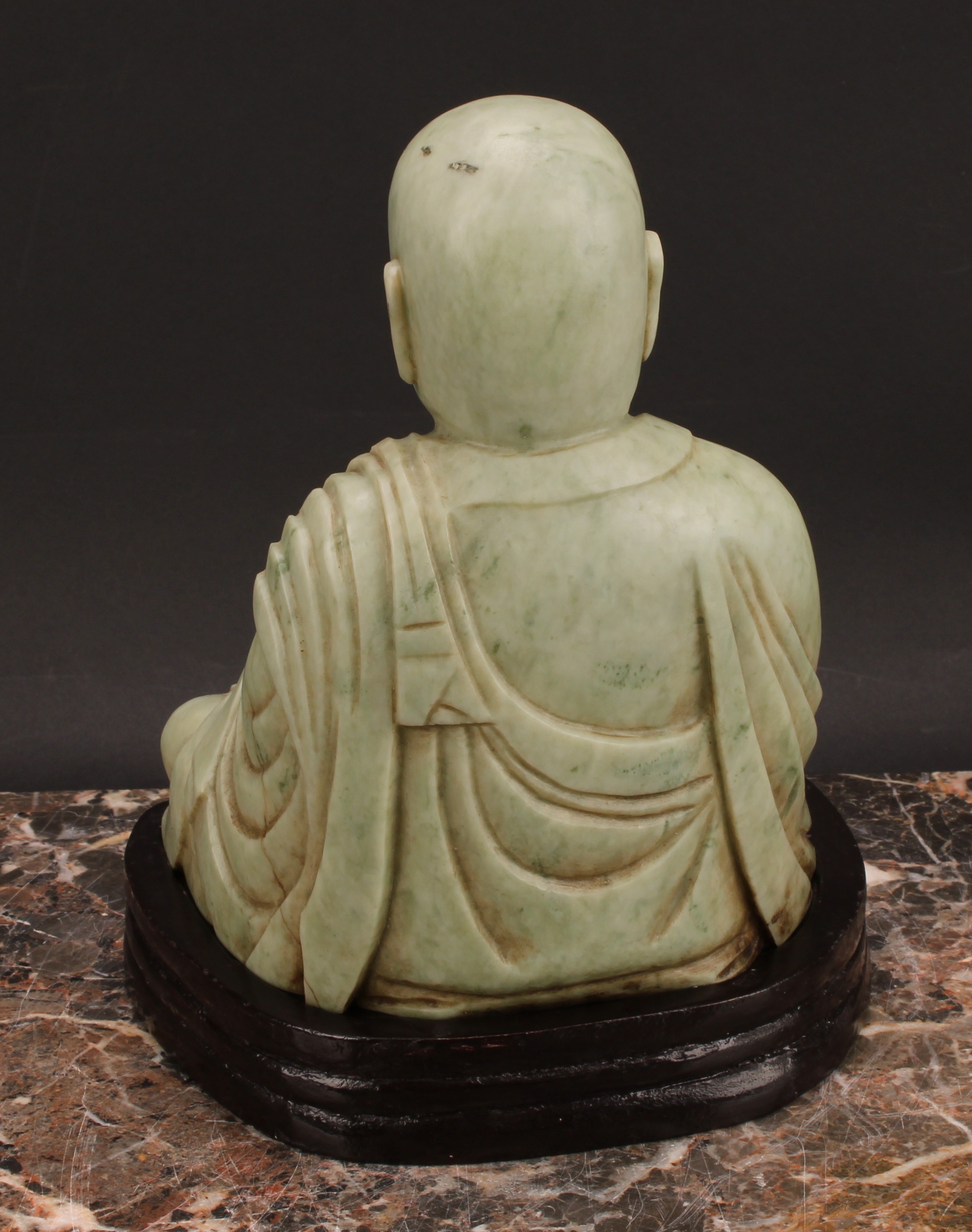 A Chinese soapstone figure, carved as a Buddhist disciple, or Luohan, holding a peach, 21cm high, - Image 4 of 4