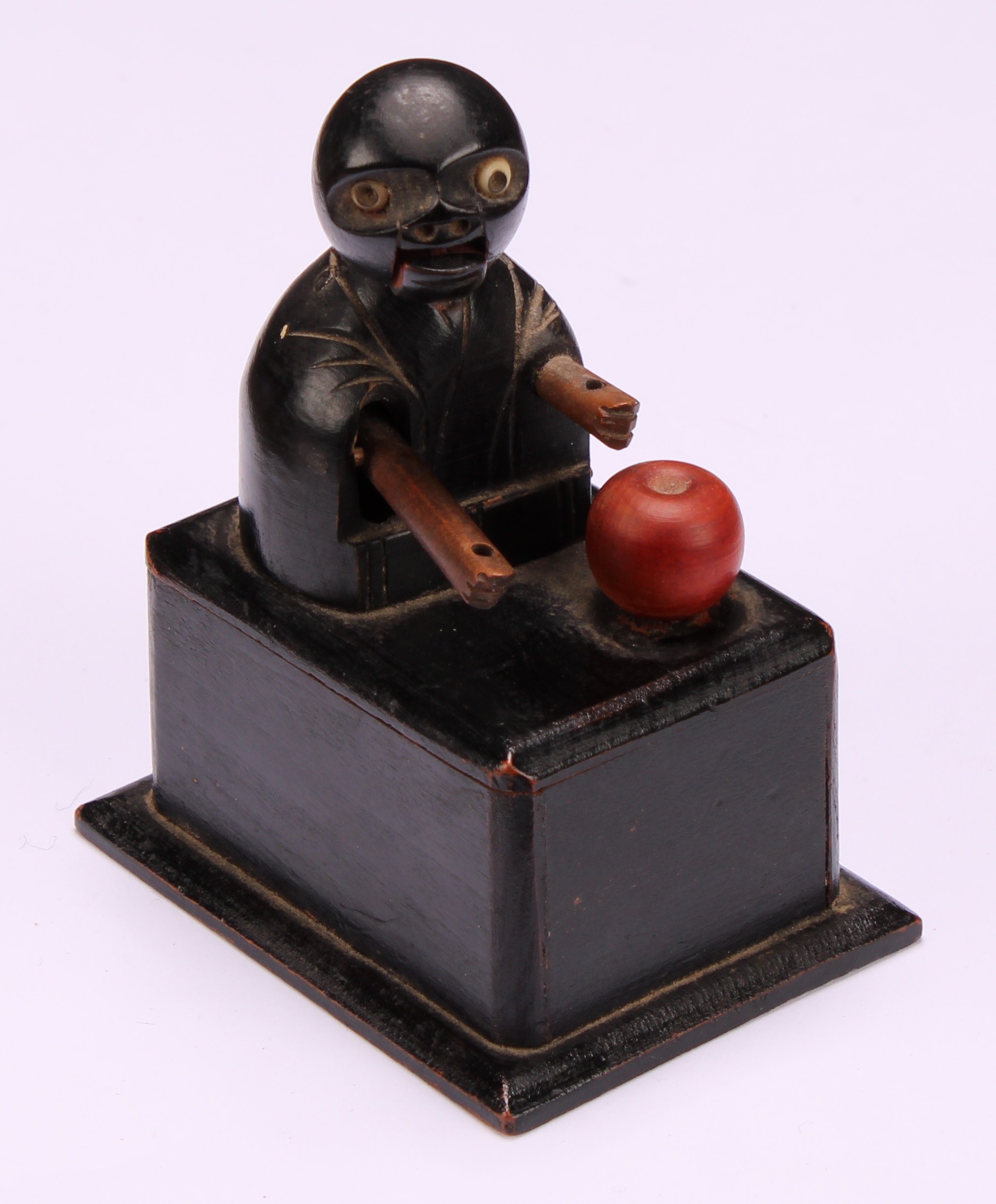 A Japanese Kobe mechanical wooden toy, as a comical figure eating an apple, rectangular base, 9cm - Image 2 of 4