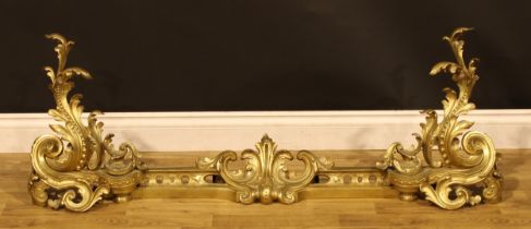 A 19th century ormolu hearth suite, comprising chenets and fire curb, cast in the Rococo taste