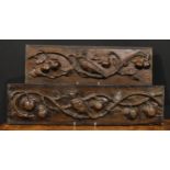 A pair of 19th century oak rectangular panels, each boldly carved with an owl amongst fruiting apple