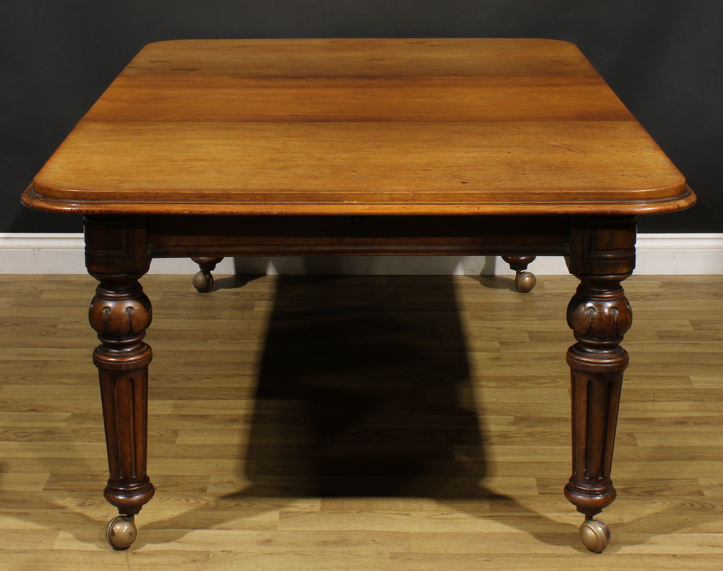 A Victorian walnut and mahogany extending dining table, rounded rectangular top with one - Image 2 of 3