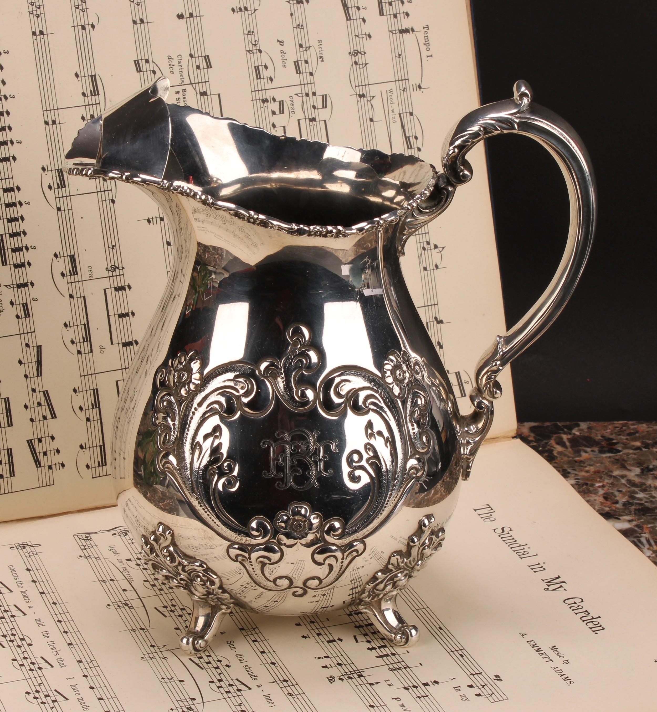 An American silver Pimm's jug, chased with flowers and scrolling leaves, 21cm high, Poole Silver Co,