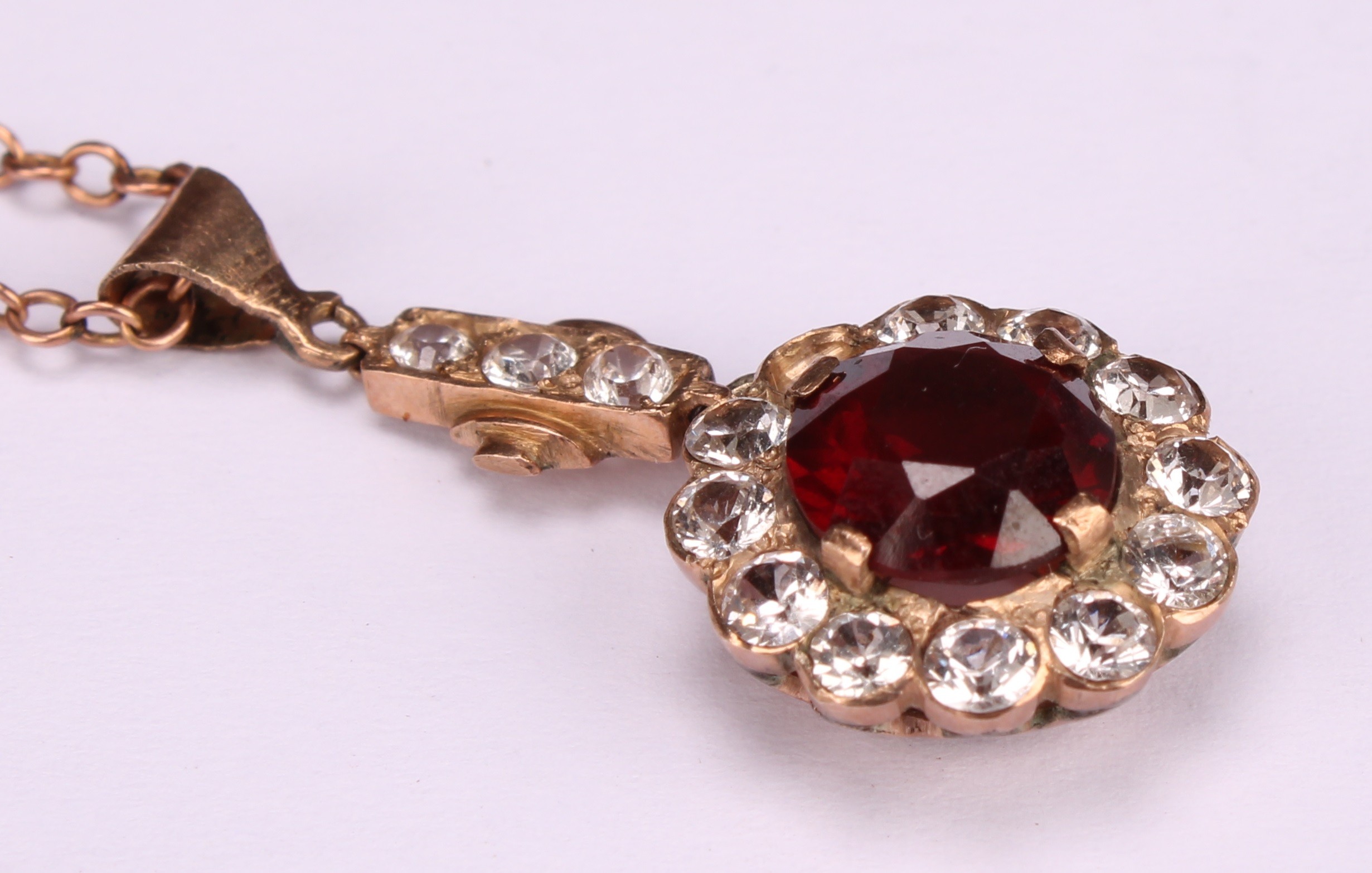 A red garnet and white stone cluster pendant, rose metal mount, suspended from a 9ct gold chain, - Image 4 of 5