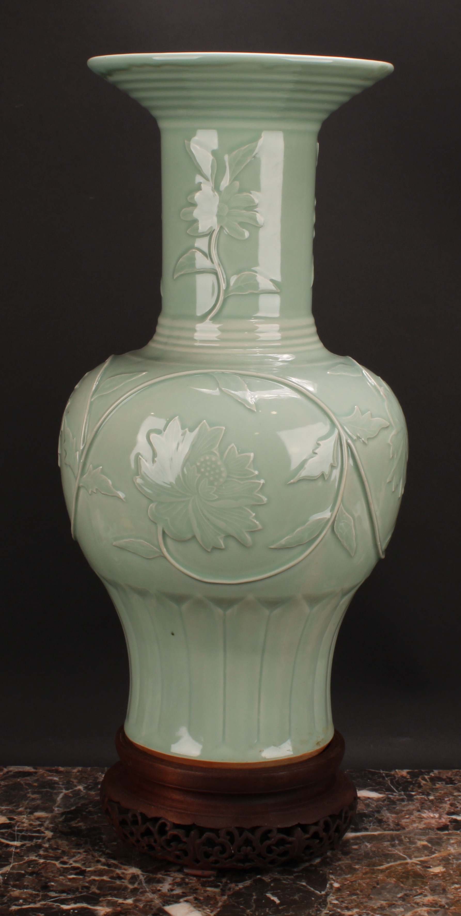 A large Chinese celadon baluster vase, moulded with lotus, 53cm high, seal mark, hardwood stand