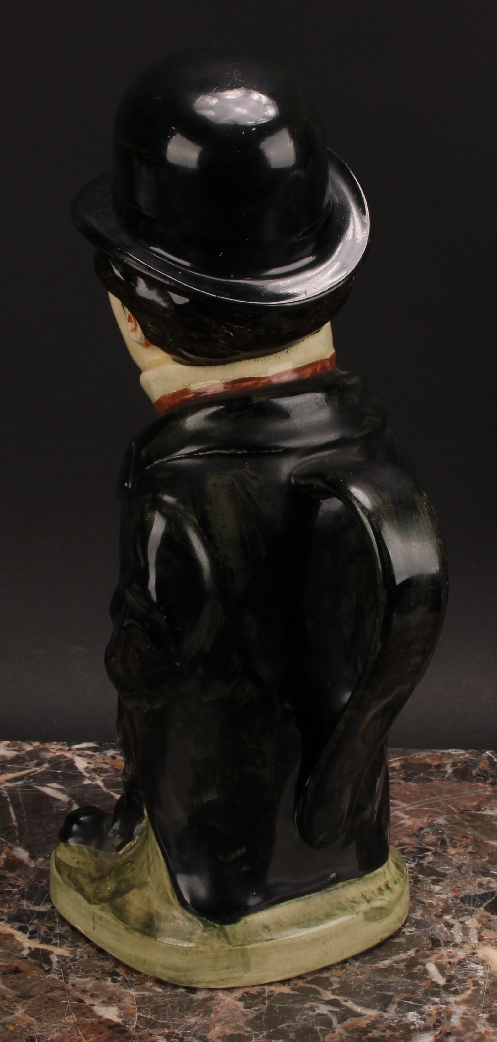 A Royal Doulton jug and cover, modelled as Charlie Chaplin, he stands wearing baggy black suit - Image 6 of 7