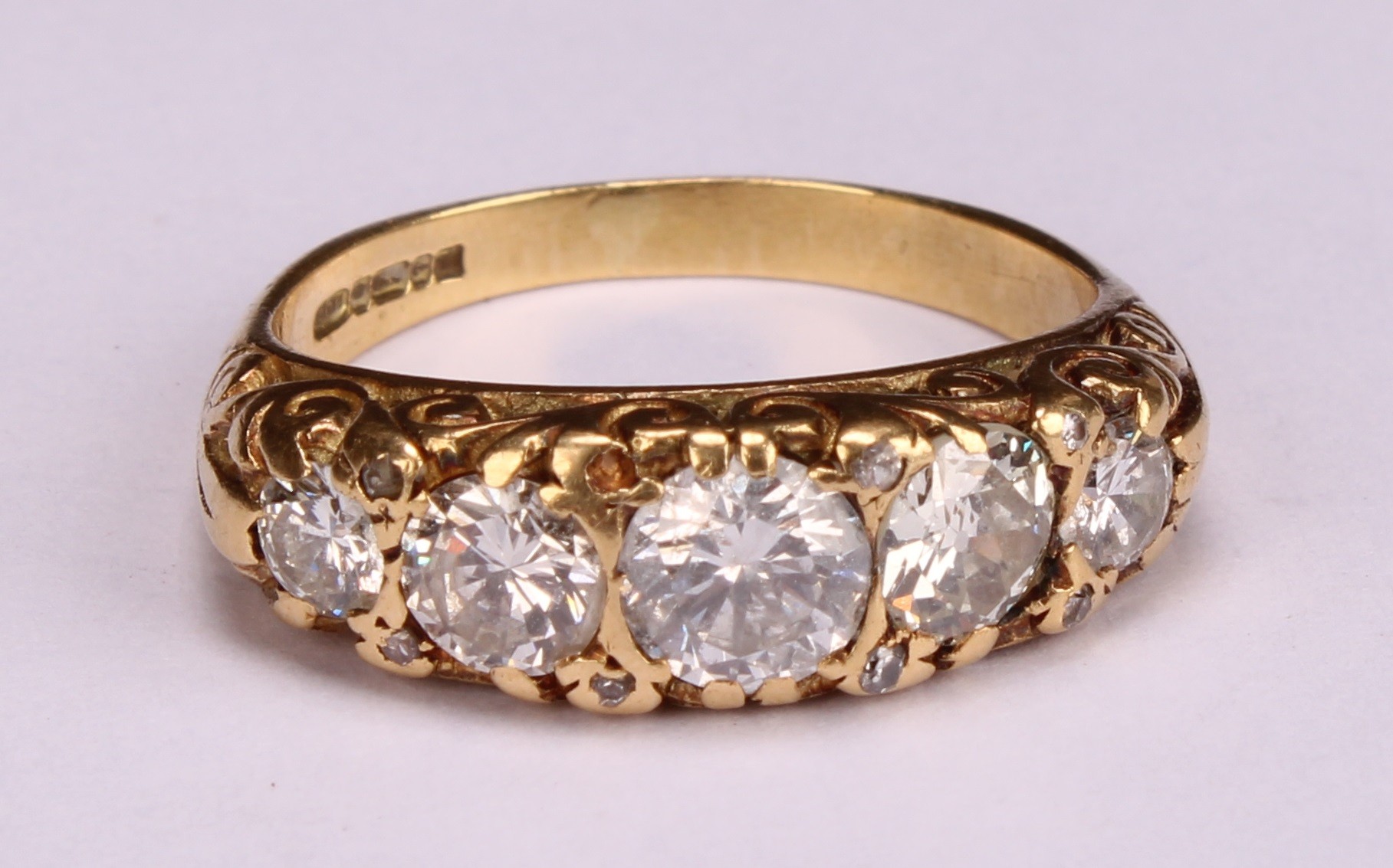 An 18ct gold five stone diamond ring, the graduated stones interspersed with diamond chips, - Image 4 of 4