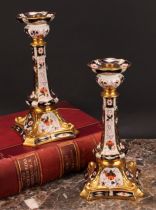 A pair of Royal Crown Derby Imari 2451 pattern Kedleston candlesticks, the square bases with