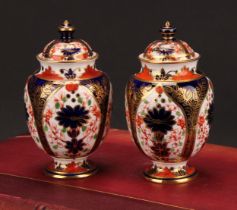 A pair of Royal Crown Derby 1128 Imari pattern ovoid pedestal vases and covers, circular bases, 13cm