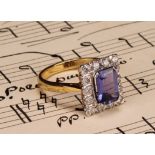 A tanzanite and diamond ring, the rectangular cushion cut stone claw set within a single band of