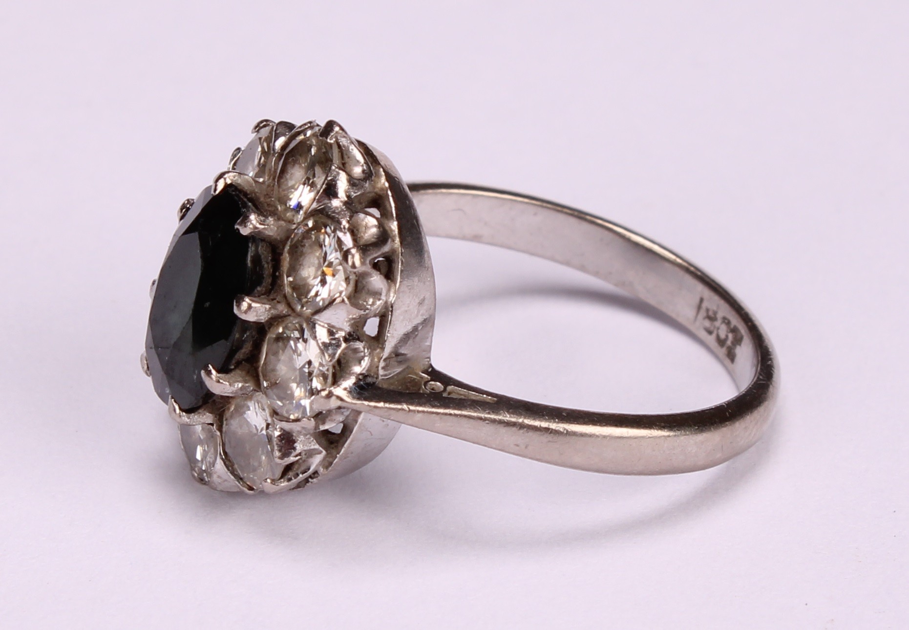 A sapphire, diamond and 18ct white gold cluster ring, the central oval facet cut stone claw set - Image 3 of 5